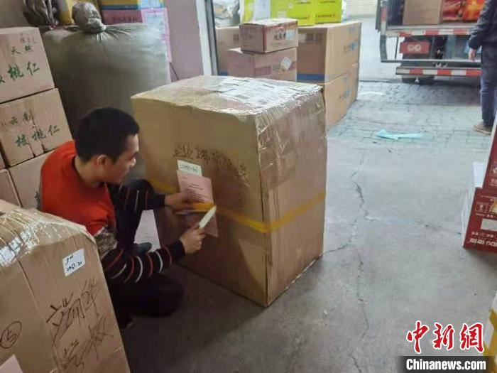 图为物流工作人员在打包装箱“暖心包”。广西侨办供图